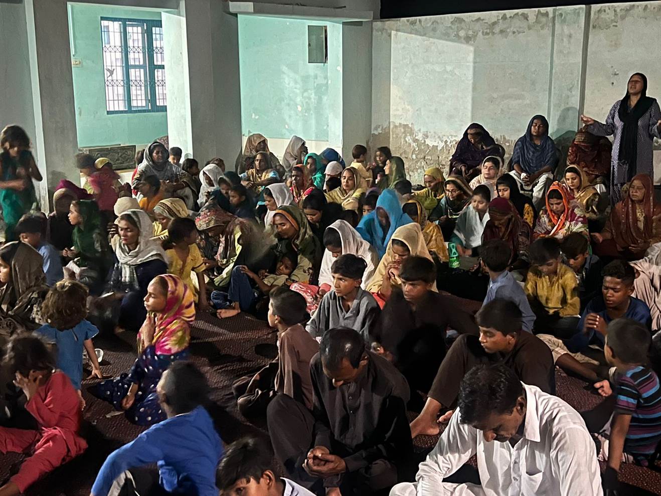 A group of people sitting on the floor

Description automatically generated