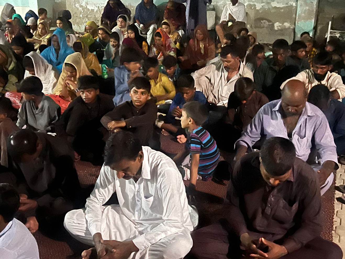 A group of people sitting on the floor

Description automatically generated