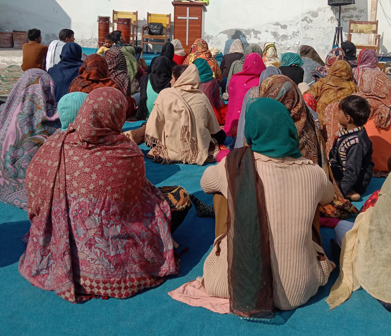 A group of people sitting on the ground

Description automatically generated with low confidence